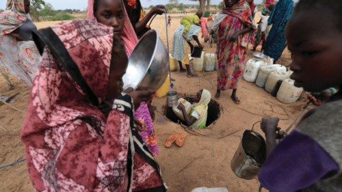 A Sudanese girl who fled the conflict in Sudan's Darfur region and newly arrived, fetches water from ...