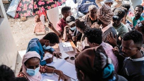 Workers register refugees who crossed from Sudan to Ethiopia at the IOM (International organization ...