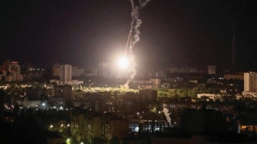 Explosion of a missile is seen in the sky over the city during a Russian missile strike, amid ...