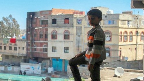 TOPSHOT - A Yemeni boy checks the damage following a mortar shell attack on the country's flashpoint ...