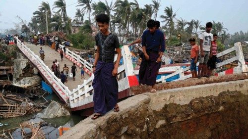 People cross a broken bridge at the Khaung Dote Khar Rohingya refugee camp in Sittwe, on May 15, ...