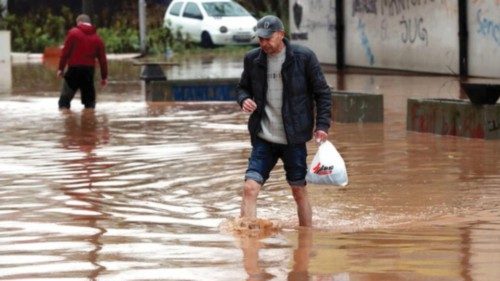 epa09566180 A man crosses a street in the flooded area of Ilidza, Sarajevo, Bosnia and Herzegovina, ...