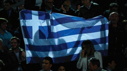 Spectators hold the flag of Greece during the quarterfinals match of the Men's ATP Rome Open tennis ...
