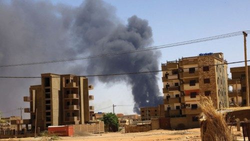 FILE PHOTO: Smoke rises above buildings after an aerial bombardment, during clashes between the ...
