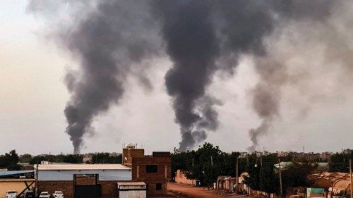 TOPSHOT - Smoke rises above buildings in Khartoum on May 24, 2023. Fighting had eased but not ...