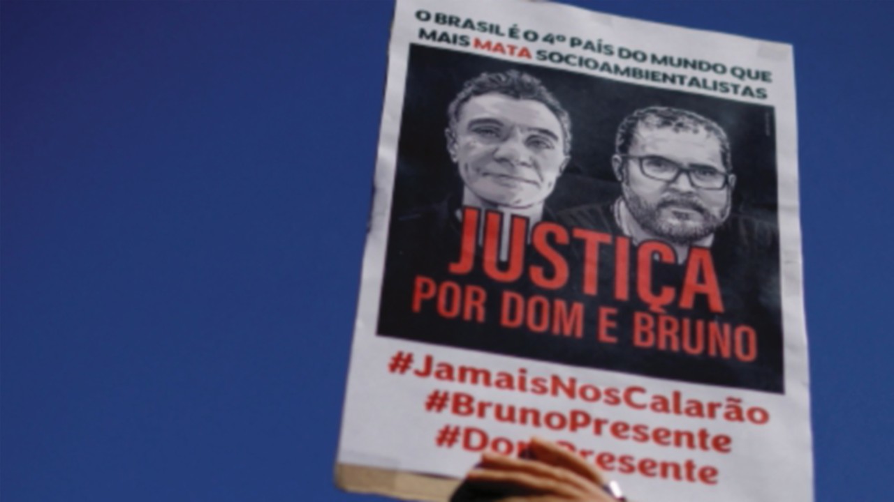 FILE PHOTO: A demonstrator holds a sign during a protest, to demand justice for journalist Dom ...