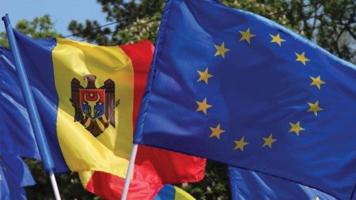 People wave flags of European Union and Moldova during a rally to support the European path of the ...