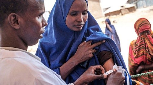 An internally displaced woman gets her arm measured during a food distribution organised by the ...