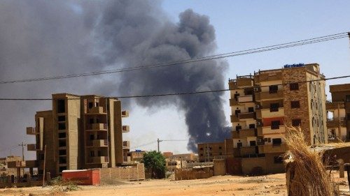 FILE PHOTO: Smoke rises above buildings after an aerial bombardment, during clashes between the ...