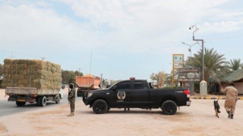 Libyan security forces man a check point in the surrounding area during the trial of jihadists ...