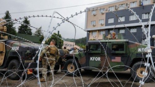 U.S. members of the NATO-led Kosovo Force (KFOR) stand guard outside municipal offices in Leposavic, ...