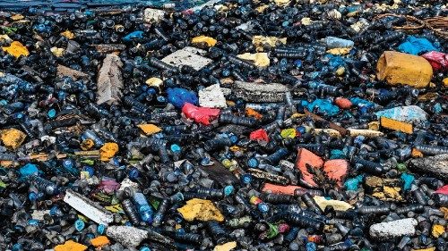 This picture shows garbage and plastic waste covered with oil on the water's surface at a port in ...