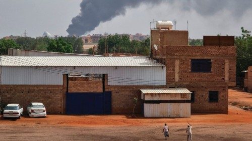 TOPSHOT - Smoke billows behind buildings from a reported fire in Khartoum, on June 5, 2023, as ...