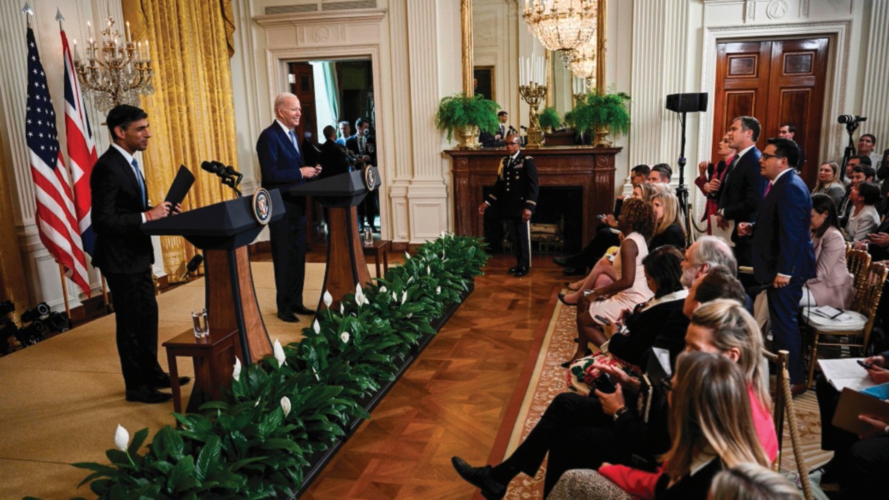 US President Joe Biden and British Prime Minister Rishi Sunak stop to answer more questions shouted ...