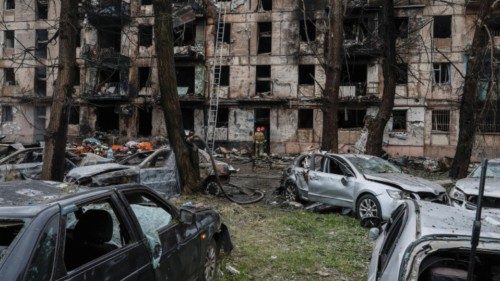 Rescuers work at a site of a residential building heavily damaged by a Russian missile strike, amid ...