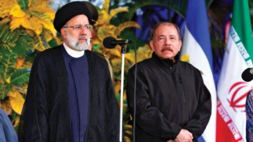 Handout picture released by Nicaragua's Presidency showing Iran's President Ebrahim Raisi (L) and ...