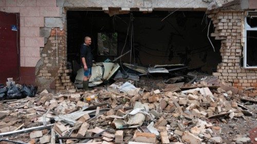 TOPSHOT - A local resident clears debris of a shop destroyed after a Russian shelling in Kherson, on ...