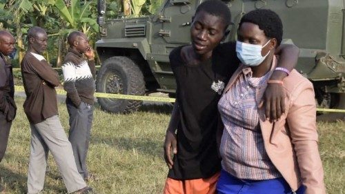 TOPSHOT - A boy is conforted at the scene of an attack in Mpondwe, Uganda, on June 17, 2023 at the ...