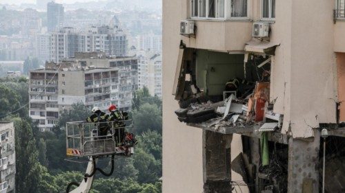 epa10709077 Rescue workers in action after an apartment block was damaged by rocket fragments in ...
