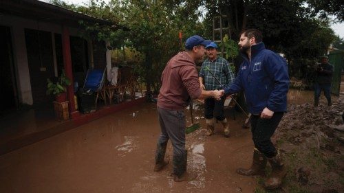 Chiles President Gabriel Boric visits a damaged house after heavy rains in O'Higgins region, Chile, ...