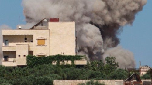 TOPSHOT - A plume of smoke rises from a building following a reported Russian air strike on Syria's ...