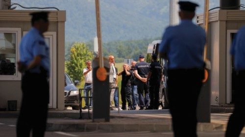 One of the released Kosovan policemen (C) arrives at the Kosovo-Serbia border crossing, in Merdare, ...