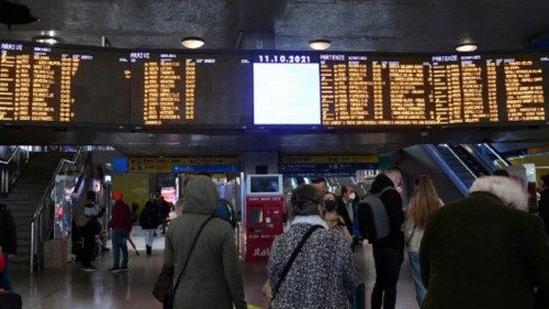 Passengers look at the arrival and departure monitor indicating the deleted trains, at the Termini ...