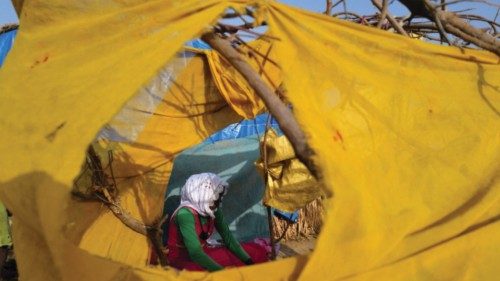 FILE PHOTO: A Sudanese refugee who has fled the violence in Sudan's Darfur region, sits at her ...