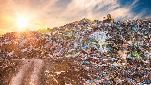 Pollution concept. Garbage pile in trash dump or landfill at sunset.