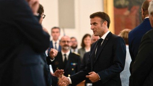 French President Emmanuel Macron (C) greets local representatives during a visit in Pau, ...