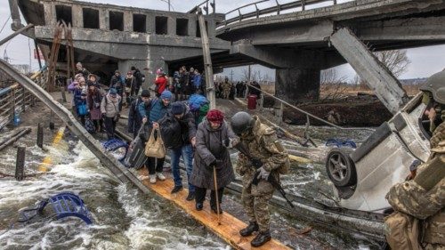 epa10731581 (FILE) - People cross the destroyed bridge as they flee from the frontline town of ...