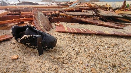 A shoe is seen amid the remains of the boat after migrants washed ashore following a shipwreck, at a ...