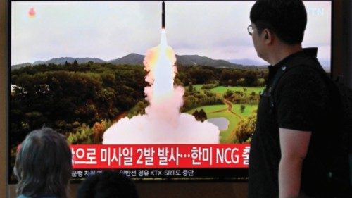 People watch a television screen showing a news broadcast with file footage of a North Korean ... People watch a television screen showing a news broadcast with file footage of a North Korean ...