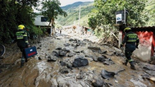 Colombia National Police rescue officers walk at an area affected by a landslide which left several ...
