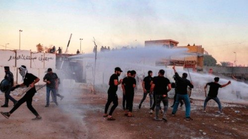 TOPSHOT - Iraqi riot police use water cannon to disperse supporters of Iraqi Shiite cleric Moqtada ...