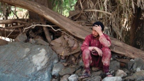 An Afghan resident sits near his house that was damaged in flash floods in the Jalrez district of ...