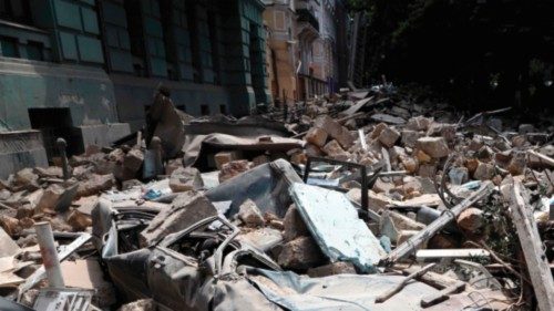 A car is covered with rubble the day after a military strike in the center of Odesa on July 24, ...