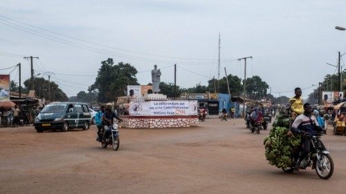 A poster urging people to vote yes in the upcoming referendum is seen next to a road in Bangui, on ...