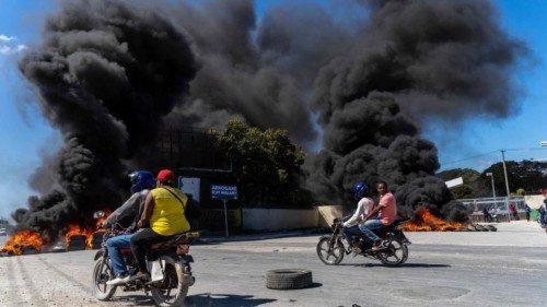 (FILES) Motorcyclists drive by burning tires during a police demonstration after a gang attack on a ...