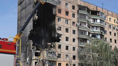 epa10778513 Ukrainian rescuers work at the site of a damaged residential building after shelling in ...
