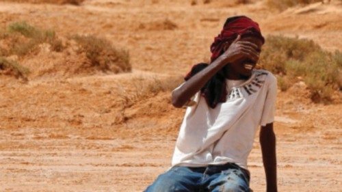 TOPSHOT - A migrant of African origin collapses due to exhaustion and dehydration upon his arrival ... TOPSHOT - A migrant of African origin collapses due to exhaustion and dehydration upon his arrival ...