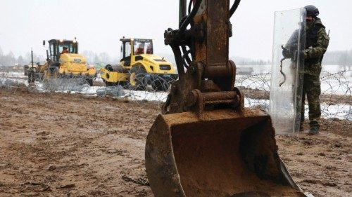 FILE PHOTO: A soldier keeps watch at the construction site of a barrier at the border between Poland ...