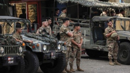 Lebanese army members secure the area where a truck overturned yesterday night, in the town of ...