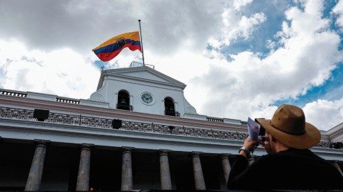 A tourist takes a picture of the Carondelet Presidential Palace with the Ecuadorean flag hoisted ... A tourist takes a picture of the Carondelet Presidential Palace with the Ecuadorean flag hoisted ...