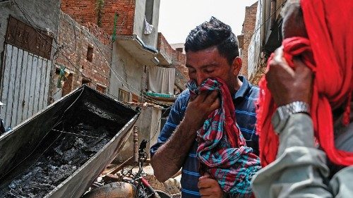 Pastor Javed Bhatti (L) weeps beside his burnt house at a Christian neighbourhood in Jaranwala on ...