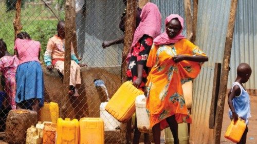 FILE PHOTO: Sudanese refugees collect water from a tap at the Gorom Refugee camp hosting Sudanese ...