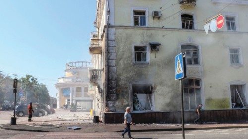 An emergency service worker stands at the site of a Russian missile strike, amid Russia's attack on ...