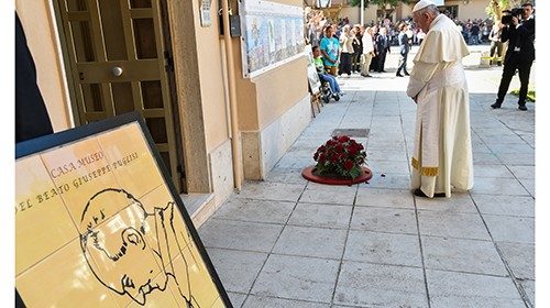 Pope Francis pays his respects by a quartz and bronze medal marking the place where late priest Pino ... Pope Francis pays his respects by a quartz and bronze medal marking the place where late priest Pino ...