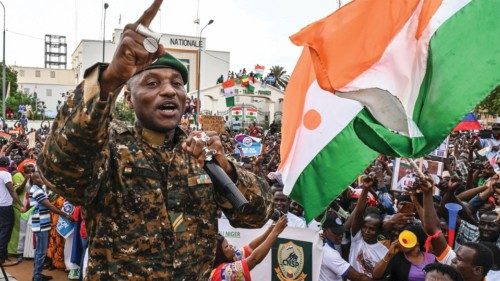 TOPSHOT - Niger's Army sergeant and artist Maman Sani Maigochi performs as supporters of Niger's ...