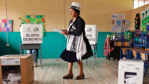 TOPSHOT - An Indigenous woman casts her vote at a polling station in Tarqui, canton of Cuenca, Azuay ...